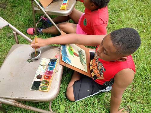 Children painting in the yard