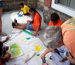 children painting with instructor